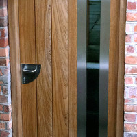 Contemporary front door with vertical panels and glazing