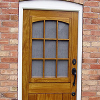 Custom glazed barn door with built-in fly screen